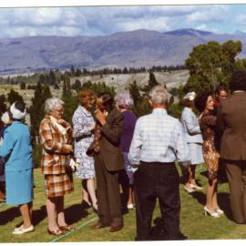 Unidentified adults talk after a service at Cromwell Church