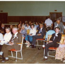 Seated parishioners fill a sports gymnasium, Cromwell Church