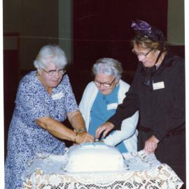 Three women cut the 100th anniversary cake for Cromwell Church