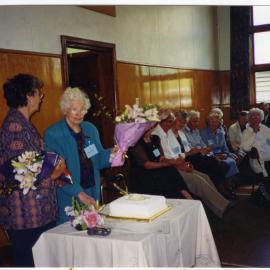Muriel Aldridge and M. Howie cutting cake, St, Columba.