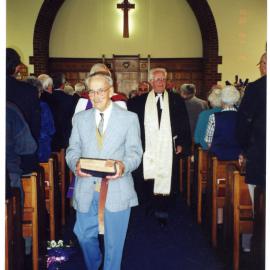 Ian McBride and H. Mawson walk down the aisle at St. Columba after a service. 