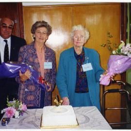 Tom Campbell, Muriel Aldridge and May Howie are about to cut a cake, holding bouquets of flowers, St. Columba, Christchurch 