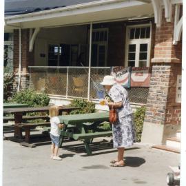 Viv Sinclair of St. Columba's Women's Fellowship speaking to an unidentified young girl at Cholmondeley Children's Home, 1999