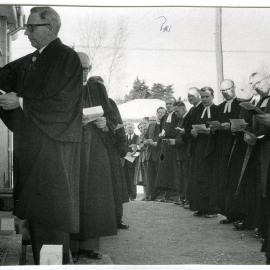 C. C. Wilson is knocking at the door, while A. Baxter looks on, during the opening of Burwood United Church