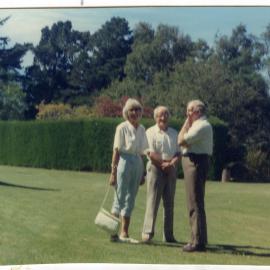 Jean Van der Luig and husband are standing with the host of Ford Milton Home, 1986