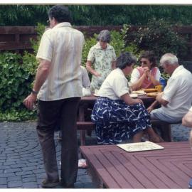 Women and men at Graham Frew's home, 1986