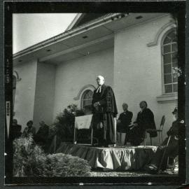 Unidentified man stands giving a speech, John Knox, Rangiora, 1972