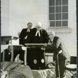 Right Reverend Luke Jenkins presents the Minister of John Knox a plaque to commemorate the centenary of the church, 1972
