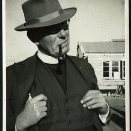 Unidentified minister smoking a pipe
