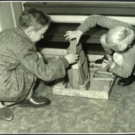 Two unidentified boys playing with blocks