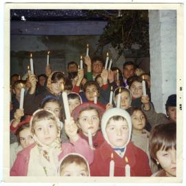 Group of unidentified children dressed warmly hold lit candles, Kaiapoi, Christchurch