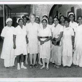 Beryl Howie stands outside the Christian Medical College and Hospital, with unidentified Indian nurses