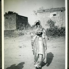"Wedding Groups," an unidentified woman walks with a bouquet during a wedding ceremony