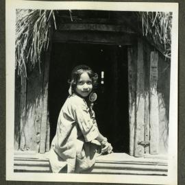 "Kashmiri Types," a young girl rests on a window ledge
