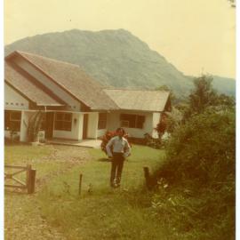 Johanes Rante Banu in Front of One of the Houses at Tangmentoe
