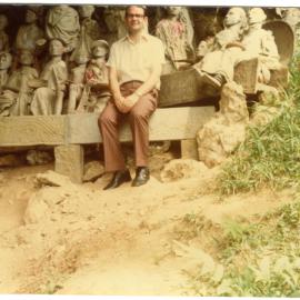 Robert Patterson in Front of the Statues of the Deceased at Kete