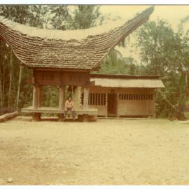 Johanes Rante Banu Sitting under a Rice Storehouse "lumbung"