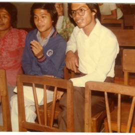 Three Students Sitting in a Hall