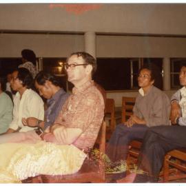 Group of Students and Staff Sitting in a Hall