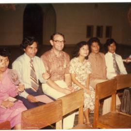 Group of Students and Staff Sitting in a Hall