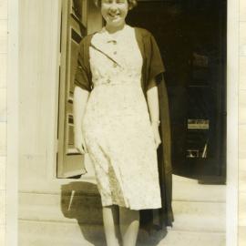 Miss Trevena, standing on steps