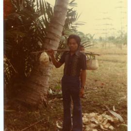 Johanes Carrying Coconuts