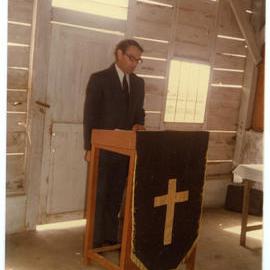 Robert Patterson at the Lectern in the Morning Church Service at Ujung Lamuru