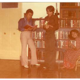 Nius Mbatono, Sergius Paul Sangkide and Emma Lazarus in Front of the Bookcase