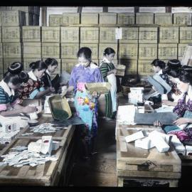 "Girls picking out sticks and unrolled leaves of tea"
