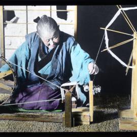 "A hand spinning wheel used by an old woman for winding a spool"