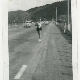 "Norm Gosling sticking to the white line - Taita to Upper Hutt," Masterton Relay, 1964, Presbyterian Harrier Club - Wellington