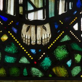 Stained glass image of the feet of Christ