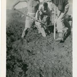 Volunteers moving mud to build Morrisons Church
