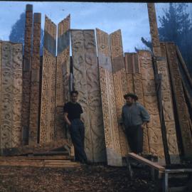 Tete and Barney Standing in Front of The Poupou They Carved