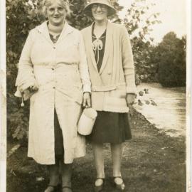 Two Unknown Women Pose Outside