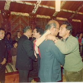 Several At A Church Service Inside a Wharenui Sharing a Hongi