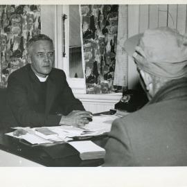 Minister In Conversation At His Desk