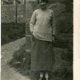 Unknown Woman Next To Stone Building