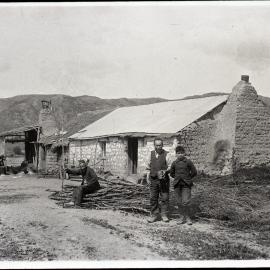 Two Unidentified Chinese Men and Young Boy Near Substantial Sod Home
