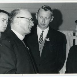Outgoing Moderator Talking With Three Others