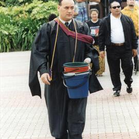 Hamish Crooks in Robes Carrying Buckets