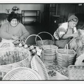 Florida Lukitau and Velina Mohetu weaving baskets