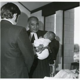 Rev L.I. Sio Baptising a Child