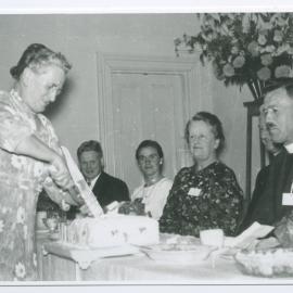 Miss Edmond cuts the cake