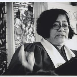 Rev. Alofa Lale in front of a stained glass window