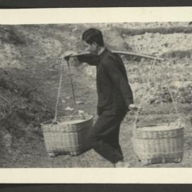 Man Carrying Baskets