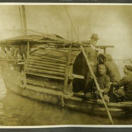 Unidentified European man sailing the Pearl River with three unidentified Chinese men, 1916