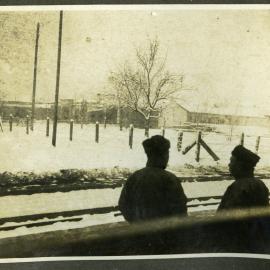 "Mukden," two unidentified men standing next to a railway station