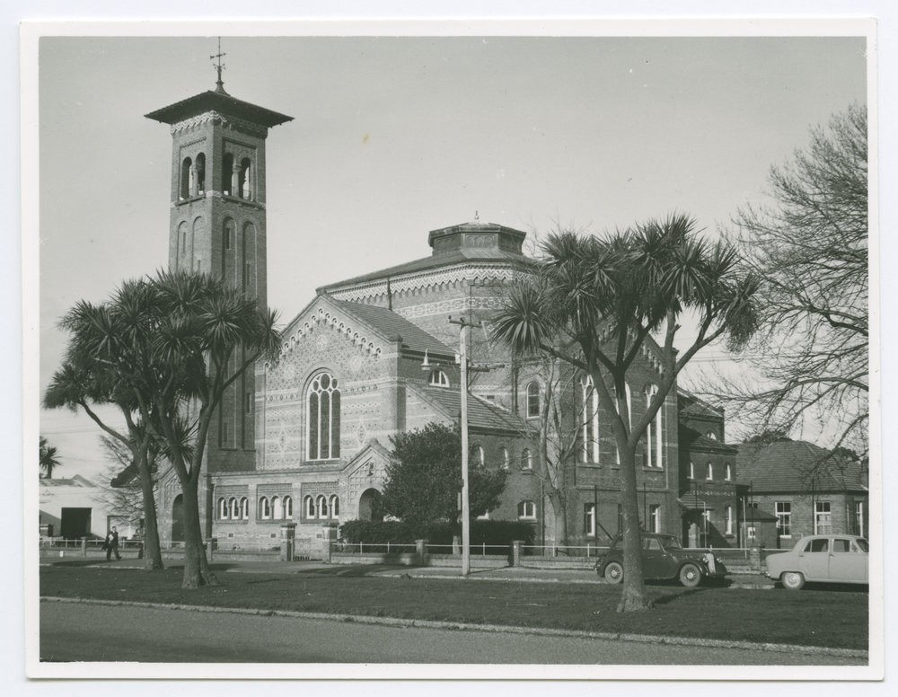 First Presbyterian Church, Invercargill, as seen from Tay Street. A Romanesque style building of patterned brickwork with a campanile style tower.  Circa 1960.
P-A57.10-28First Presbyterian Church, Invercargill, as seen from Tay Street. A Romanesque style building of patterned brickwork with a campanile style tower.  Circa 1960.
P-A57.10-28